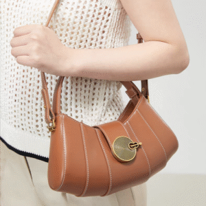 Vintage - inspired Rustic Caramel Leather Crescent Handbag with Ornate Golden Swirl Lock