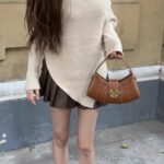Vintage - inspired Rustic Caramel Leather Crescent Handbag with Ornate Golden Swirl Lock