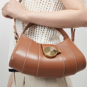 Vintage - inspired Rustic Caramel Leather Crescent Handbag with Ornate Golden Swirl Lock