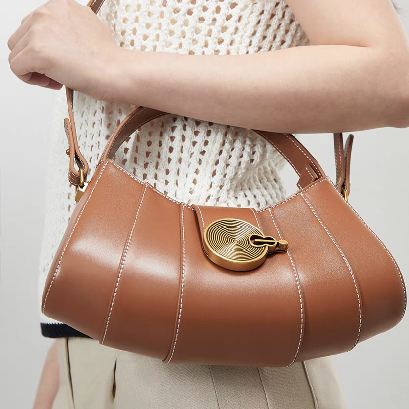 Vintage - inspired Rustic Caramel Leather Crescent Handbag with Ornate Golden Swirl Lock