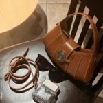 Vintage - inspired Rustic Caramel Leather Crescent Handbag with Ornate Golden Swirl Lock