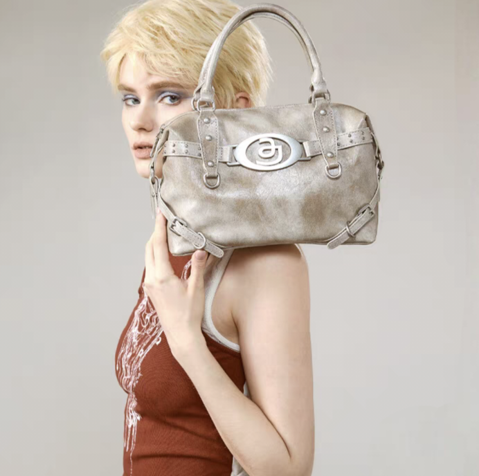 Wasteland Radiance: Distressed Metallic Leather Handbag with Apocalyptic - inspired Studs and Badge