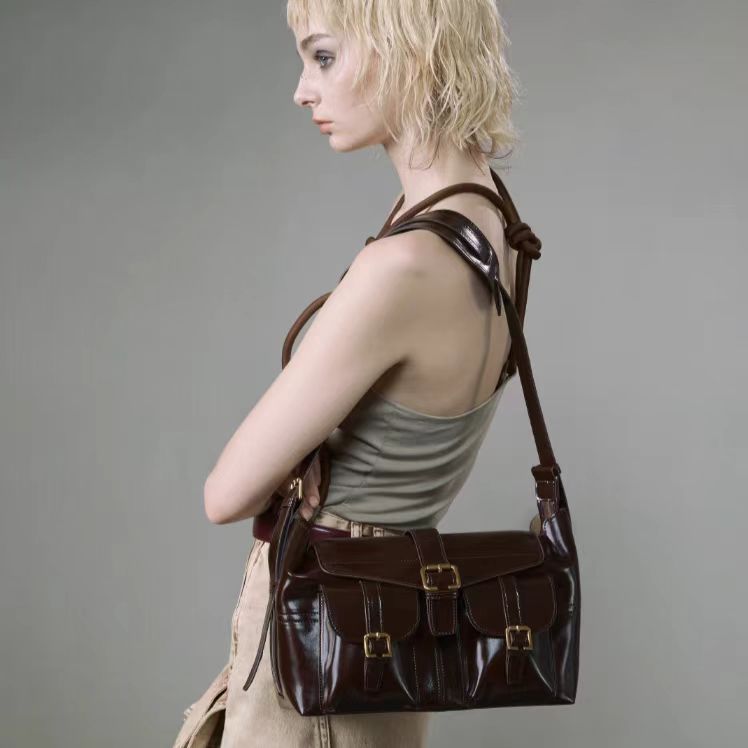 Opulent Reverie: Sumptuous Dark - toned Leather Shoulder Bag with Gleaming Gold Fasteners