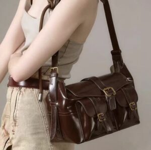 Opulent Reverie: Sumptuous Dark - toned Leather Shoulder Bag with Gleaming Gold Fasteners
